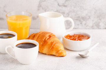 Hot coffee, croissants on a light background, selective focus.