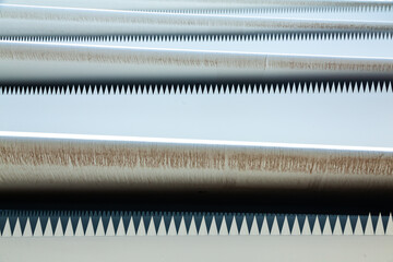 The edges of the blades of a windmill with jagged protrusions, folded for transportation.