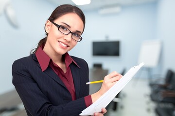 Happy business woman posing in modern office.