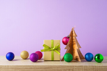 Christmas holiday background with gift box and  decoration on wooden shelf over purple background. Trendy colorful greeting card
