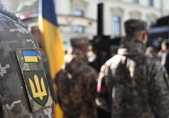 Ukrainian flag on military uniform. A funerals of Ukrainian servicemen.