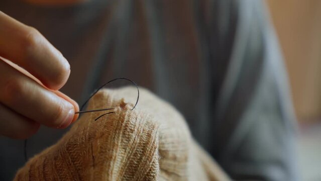 Mending clothes. Sewing supplies and old clothes for repair. Needlework, recycling and thrift. Selective focus