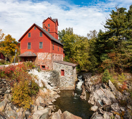 Side view of the Old Red Mill by the creek in Jericho Vermont during the fall