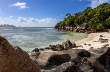 Fototapeta na wymiar Granite Rocks at a tropical beach on island La Digue in Seychellese