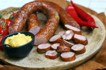 Fresh homemade sausages on a wooden tray.