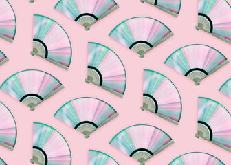 Minimal retro abstract concept with compact disc made fans with rainbow reflections on isolated background. Light diffraction into iridescent pastel pink-blue-purple-green spectrum. Music texture.