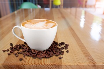 A cup with tasty aroma coffee on wooden table