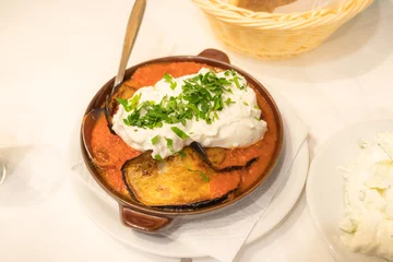 Gardinen Eggplant in tomato sauce and feta cheese. Greek dish in a pan in Athens © Bar