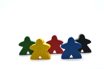 Colorful board game meeples on a white background. Concept for games night, Euro games and team work.