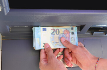 hand with money Euro banknotes withdrawn from the ATM