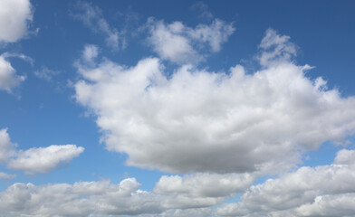 Naklejka na ściany i meble blue background with high white clouds on a spring day