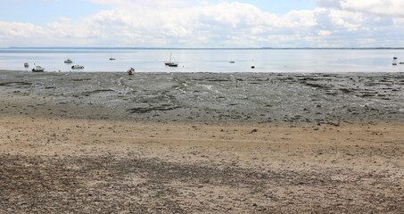 Fototapeta na wymiar beached boats stranded on sand at low tide