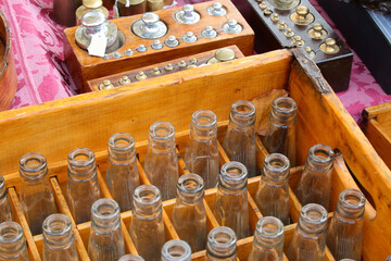 old glass bottles and other vintage material for sale in the flea market