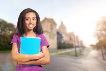 Fototapeta premium Happy female student outdoor standing near her college