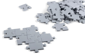 Grey puzzle pieces on light background