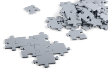 Grey puzzle pieces on light background