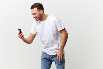 Cheerful smiling tanned handsome man in basic t-shirt talk by video call with friends posing isolated on over white studio background. Copy space Banner Mockup. Distance online communication concept