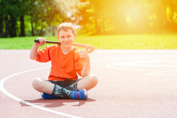 Boy playing field hockey with stick. Concept of a sports lifestyle, training, camp, leisure,...