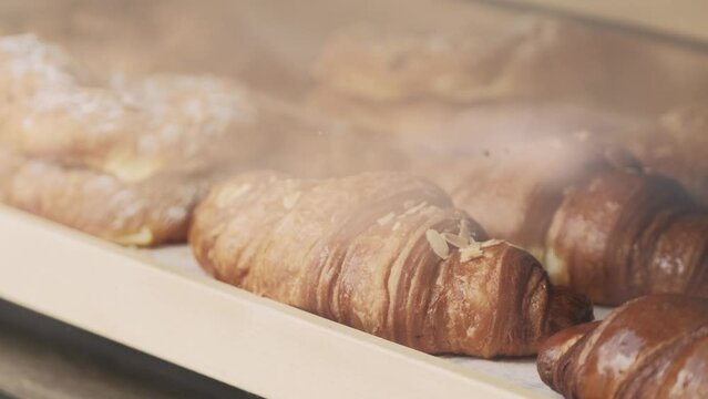 Close ip footage of beautiful tasty fresh croissants on shop.
