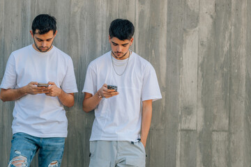 two young friends on the street with mobile phone