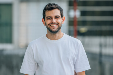 portrait of young man on the street smiling