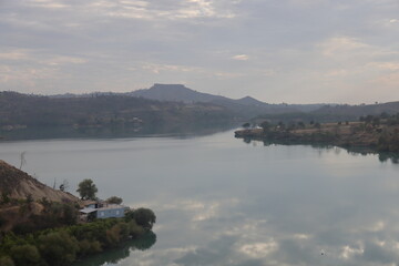 Sunset with Trees and City Silhouettes Against A Beautifully Colored Sky At River Manavgat.