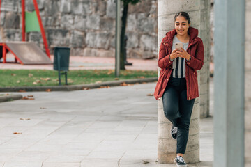 girl on the street with mobile phone full body