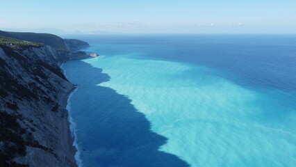 The turquoise blue Mediterranean sea and the high cliffs of the Greek islands