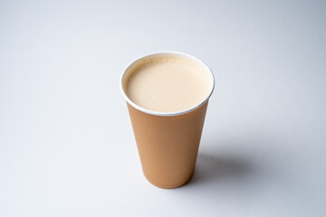 coffee with soy milk in a disposable cardboard craft cup