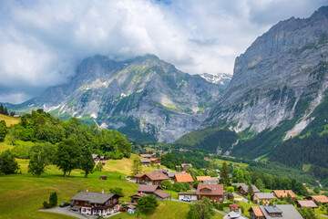 Swiss alpine village - high angle view of Grindelwald valley on a cloudy day; view from the gondola, Switzerland