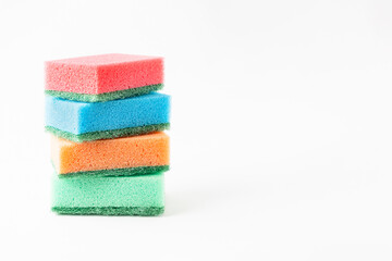 Foam sponges for dishes lined up in a stack on a white background, space for text.