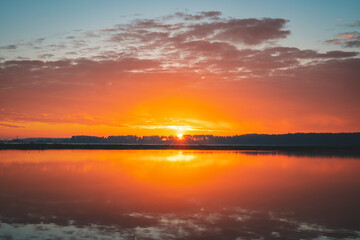 Naklejka na ściany i meble sunrise over the lake