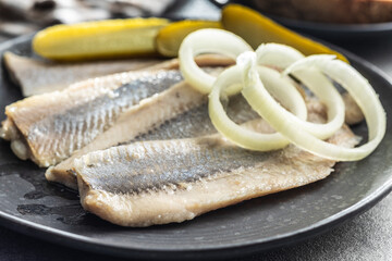 Marinated herring fish on plate.