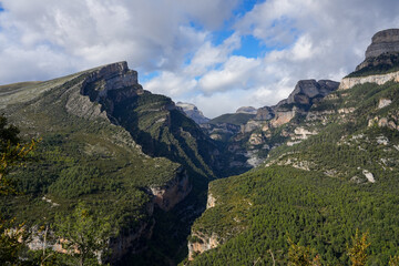 magnificent view of Pyrenees mountains with rock outcrops and forest covered slopes