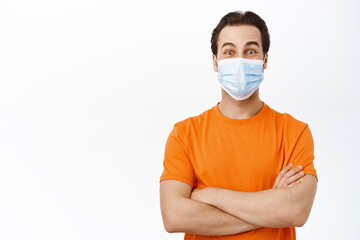 Handsome healthy man in medical face mask. Covid-19 preventive measures campaign.