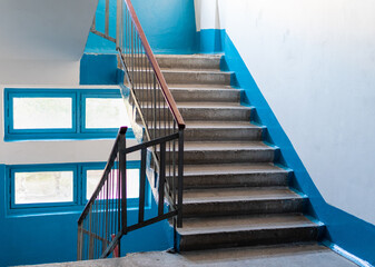 Interior of multi-storey residential building with stairs between floors