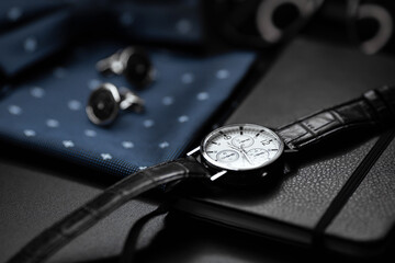 Business accessories. Mens watch and cufflinks isolated on black background. - Powered by Adobe