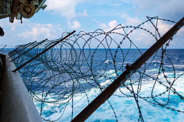 Ship's stern fortified with razor wire. Anti piracy protection is mounted before entering (HRA) Piracy High Risk Areas to prevent illegal boarding.