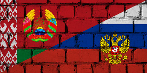 Flags of Russia and Belarus on a brick wall. Concept of cooperation between two countries