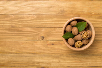 Fresh walnuts on wooden background, top view