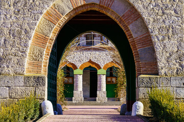 Fototapeta na wymiar Stone arch at the entrance to the old stone church. Background with selective focus and copy space