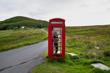 English phone booth in a village on the north of the Isle of Skye in the Scottish Highlands