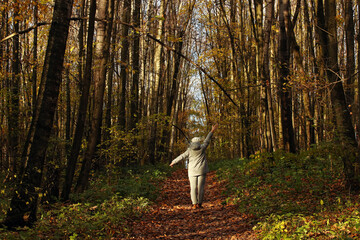 Woman in grey jacket in autumn colourful forest. Photo was taken 14 October 2022 year, MSK time in Russia. - 539582133