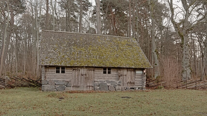 Obraz premium Old wooden house in a meadow in the Estonian open air museum, Tallinn 