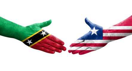 Handshake between Liberia and Saint Kitts and Nevis flags painted on hands, isolated transparent image.