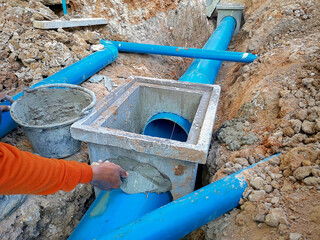 Construction of underground sewers. Workers constructing underground sewers.