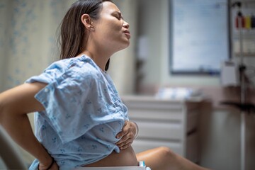A woman in labor having contractions in the hospital delivery room. Childbirth and pregnancy.