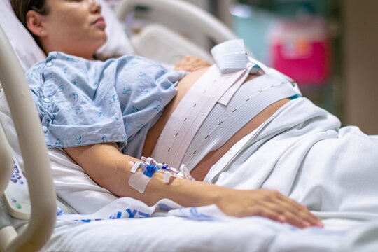 A woman in labor, giving birth in the hospital. Childbirth and pregnancy.