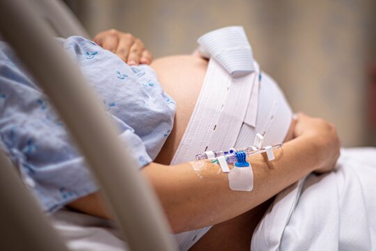 A pregnant woman having contractions, waiting to give birth in the hospital.