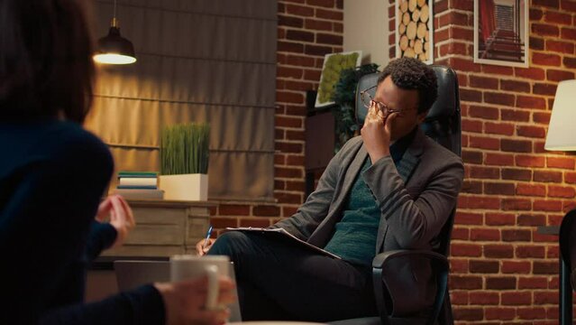Marriage counselor consulting unhappy couple in relationship, dealing with marriage problems and conflict. Listening to displeased people to do counseling psychoanalysis at therapy.